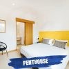 Mythic Suites and Villas yellow-guest-bedroom-suite-penthouse-mythic-resort