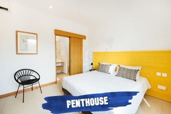 Mythic Suites and Villas yellow-guest-bedroom-suite-penthouse-mythic-resort